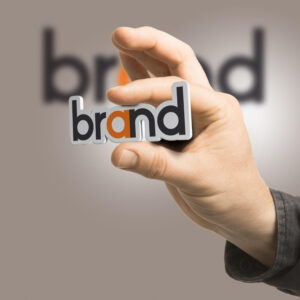 Brand identity concept showing hand holding the word brand for logo and branding design